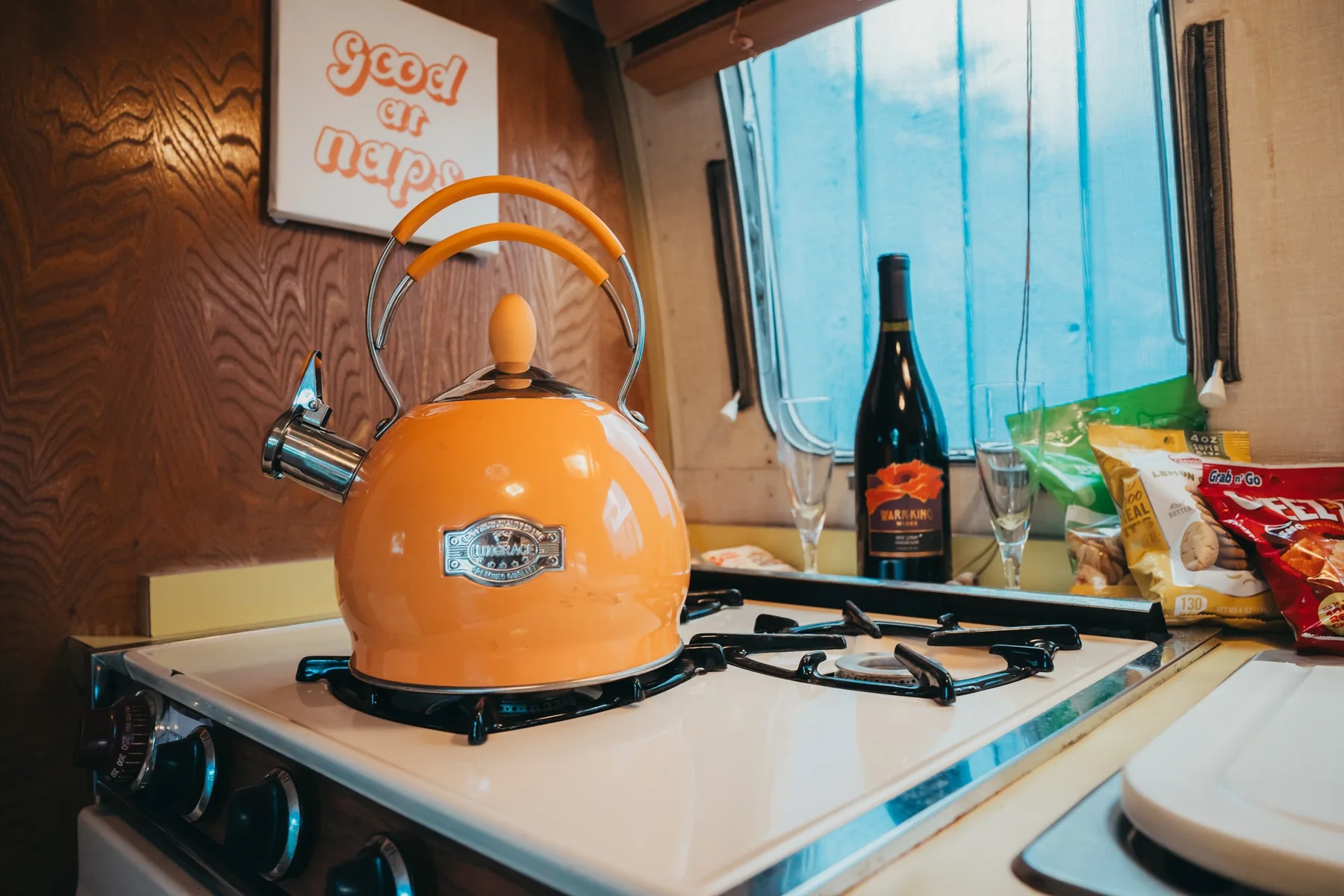 Close-up of Caravel kitchen retro orange kettle and gas range