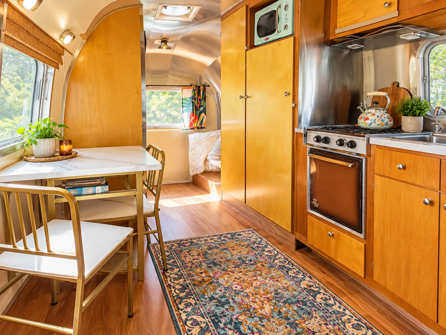 Actual Safari interior with warm wood cabinetry, dining table and vintage kitchen